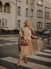 A lady wears a tulle skirt.